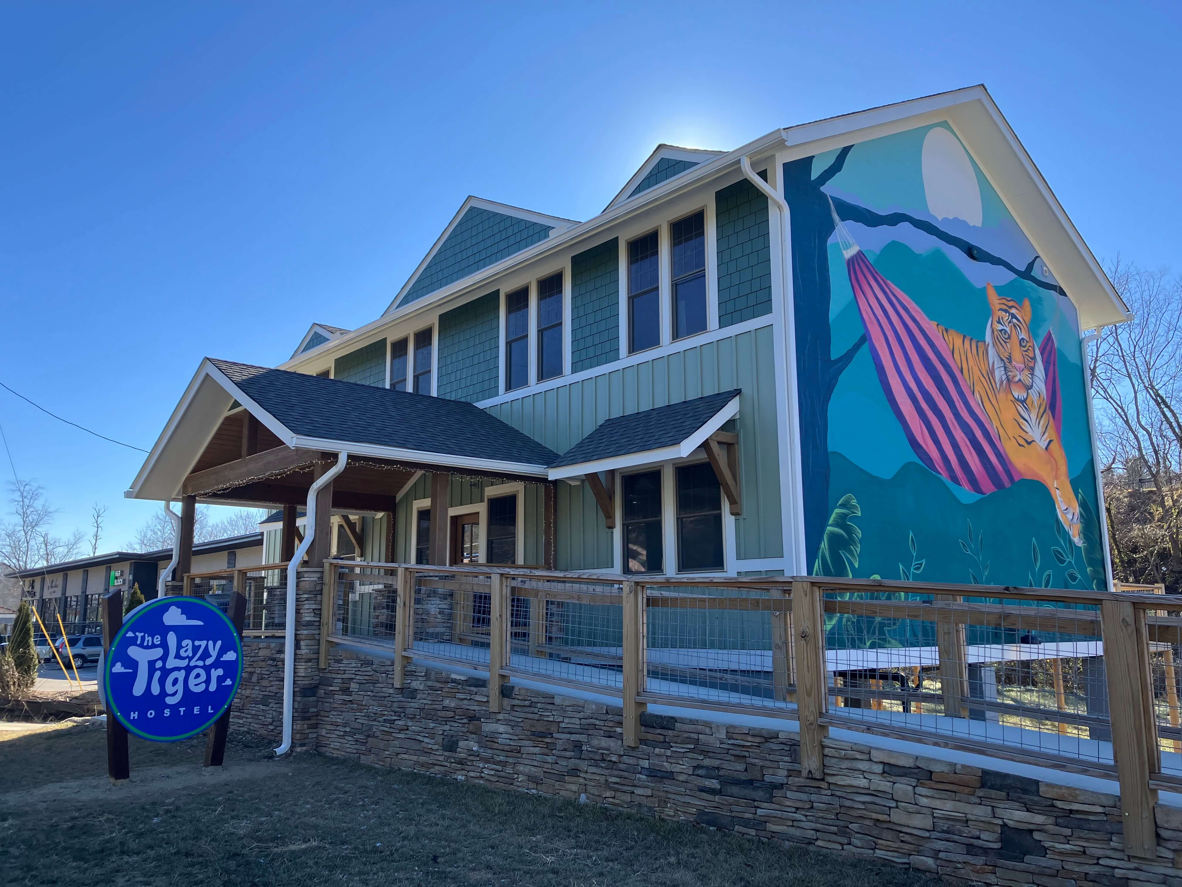 The Lazy Tiger Hostel with new monument sign and mural
